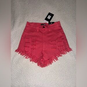 Pink ripped denim shorts